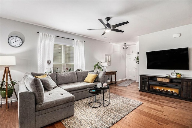 1000 Eight Knot Ct, Greensboro, GA 30642 - living area featuring ceiling fan, wood finished floors, and baseboards