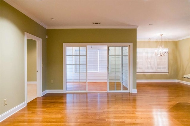 105 Maplecrest Ln, Rome, GA 30161 - unfurnished room featuring light wood-type flooring, a chandelier, and ornamental molding