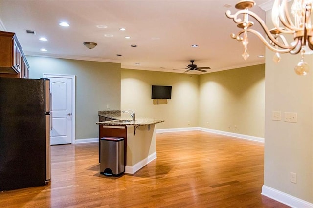 105 Maplecrest Ln, Rome, GA 30161 - kitchen featuring freestanding refrigerator, ornamental molding, a ceiling fan, light stone countertops, and light wood-style flooring