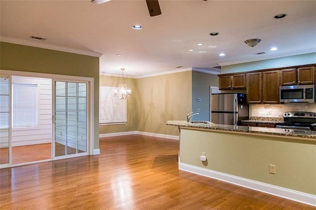 105 Maplecrest Ln, Rome, GA 30161 - kitchen featuring appliances with stainless steel finishes, ornamental molding, decorative backsplash, light wood-style flooring, and a ceiling fan