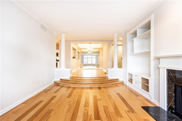 220 Renaissance Pkwy NE Unit 1105, Atlanta, GA 30308 - hallway with light wood-style floors, ornate columns, and built in shelves