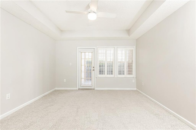 220 Renaissance Pkwy NE Unit 1105, Atlanta, GA 30308 - carpeted empty room with a tray ceiling and a ceiling fan