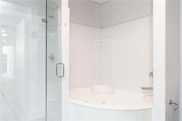 220 Renaissance Pkwy NE Unit 1105, Atlanta, GA 30308 - full bath featuring a jetted tub, a shower stall, and tile walls
