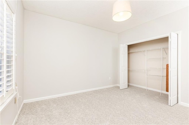 220 Renaissance Pkwy NE Unit 1105, Atlanta, GA 30308 - unfurnished bedroom with light colored carpet and a closet