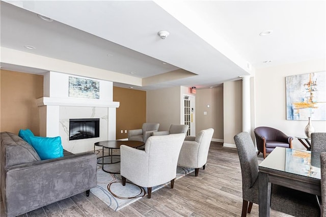 220 Renaissance Pkwy NE Unit 1105, Atlanta, GA 30308 - living area featuring wood finished floors, a fireplace, a raised ceiling, and recessed lighting