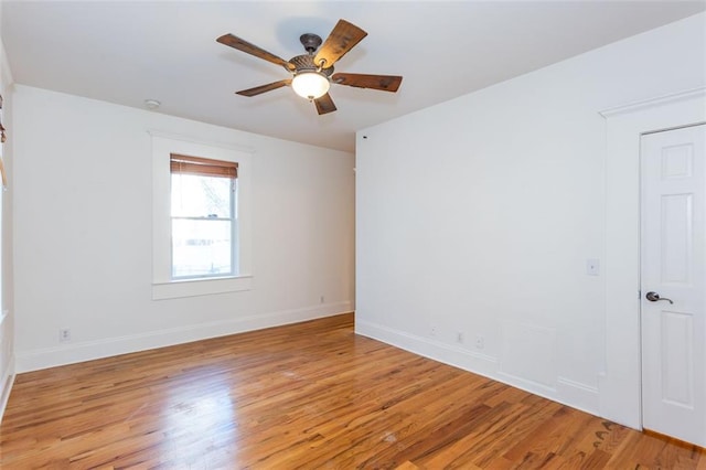 unfurnished room featuring baseboards, light wood-style flooring, and ceiling fan