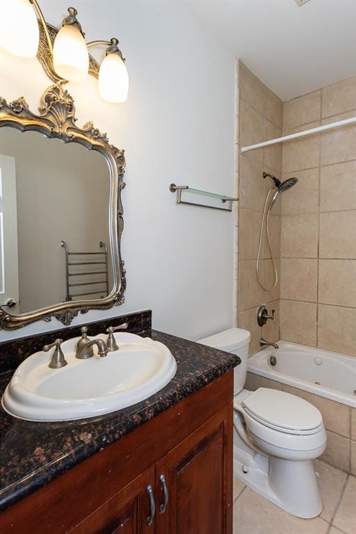 full bath featuring toilet, tiled shower / bath, tile patterned flooring, and vanity