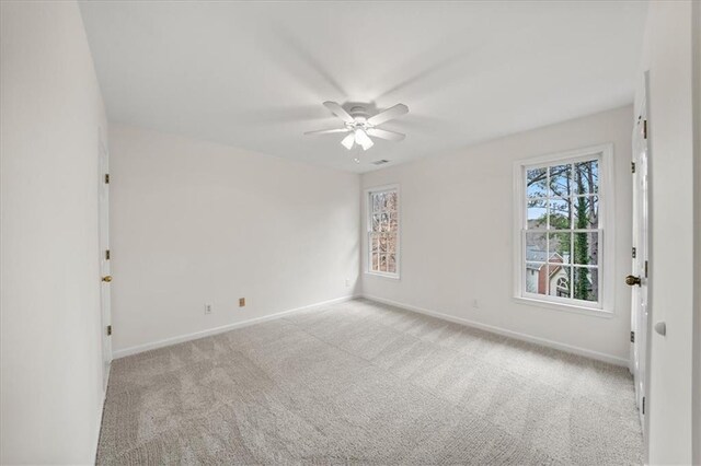 spare room featuring ceiling fan and light carpet