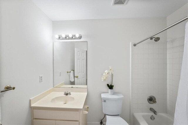 full bathroom with vanity, shower / bath combination with curtain, and toilet