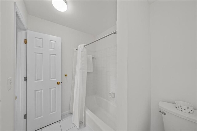 bathroom featuring tile patterned floors, toilet, and shower / bath combo