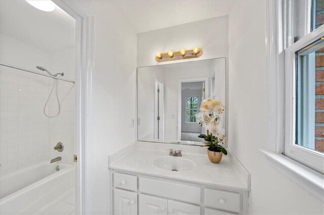 bathroom featuring vanity and tiled shower / bath combo