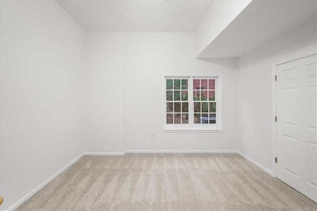 unfurnished room with light carpet