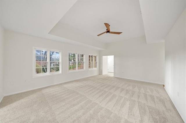 spare room featuring light colored carpet and ceiling fan