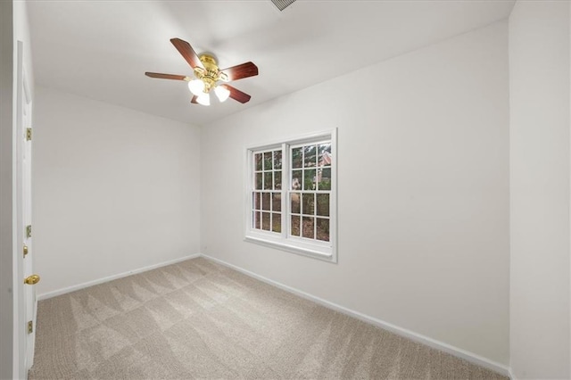 unfurnished room featuring light carpet and ceiling fan