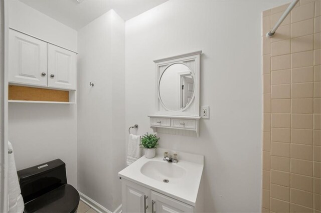 bathroom featuring vanity and tiled shower