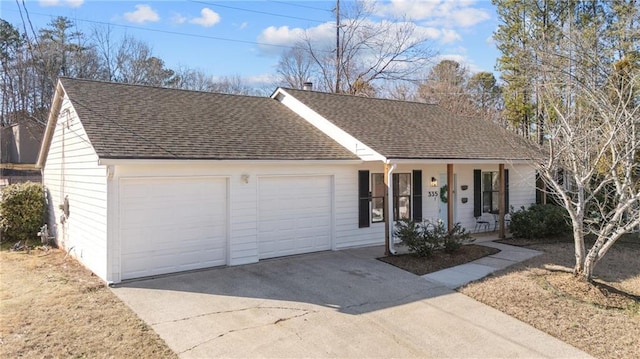 ranch-style house with concrete driveway, roof with shingles, an attached garage, and covered porch