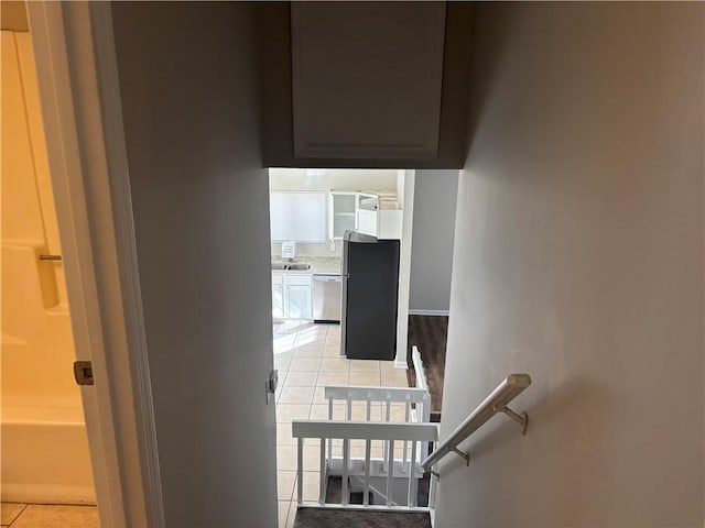 staircase featuring tile patterned floors