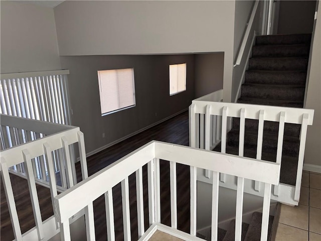 stairway with tile patterned flooring and baseboards