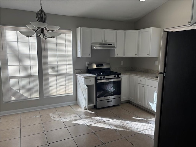 kitchen featuring light tile patterned flooring, under cabinet range hood, stainless steel appliances, white cabinetry, and hanging light fixtures