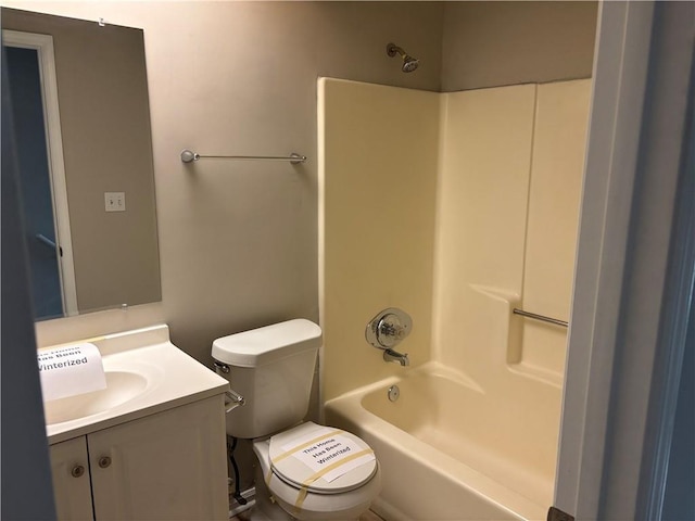 bathroom with toilet, shower / bathing tub combination, and vanity