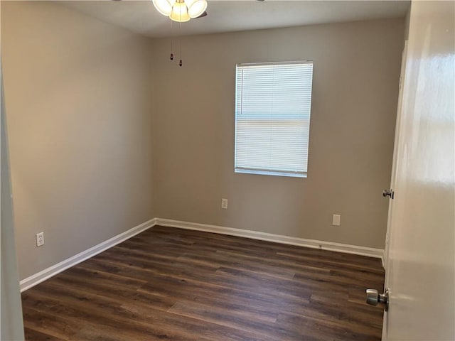 empty room featuring dark wood-style floors, ceiling fan, and baseboards