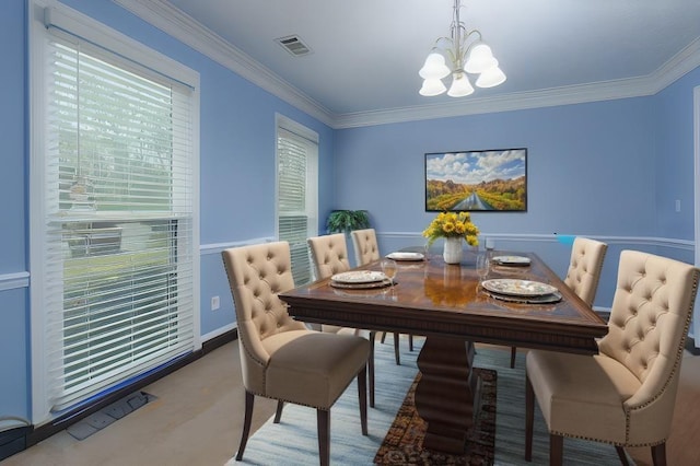 dining room with ornamental molding and a chandelier