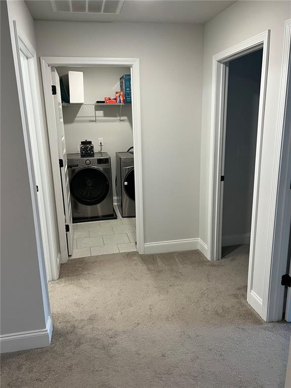 washroom with separate washer and dryer, carpet floors, and baseboards