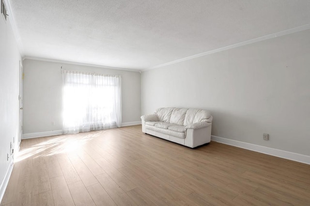 living area featuring ornamental molding and wood-type flooring