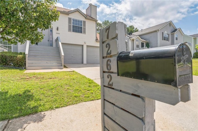 7262 Sandpiper Way, Riverdale, GA 30274 - view of front facade featuring a garage, driveway, a chimney, and a front lawn
