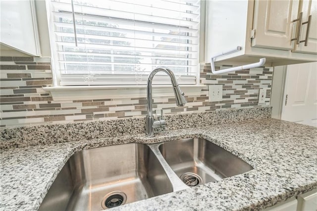 7262 Sandpiper Way, Riverdale, GA 30274 - kitchen view of a sink, tasteful backsplash, and light stone countertops