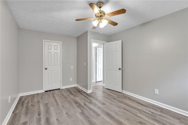7262 Sandpiper Way, Riverdale, GA 30274 - unfurnished bedroom with wood finished floors, baseboards, a textured ceiling, and a ceiling fan