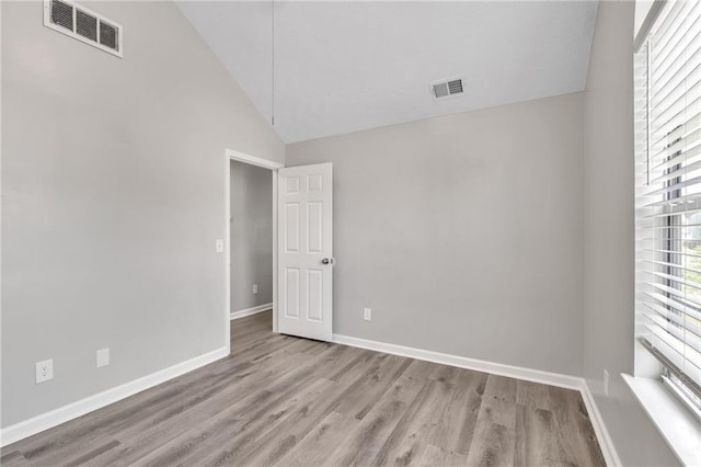 7262 Sandpiper Way, Riverdale, GA 30274 - spare room with wood finished floors, baseboards, and high vaulted ceiling