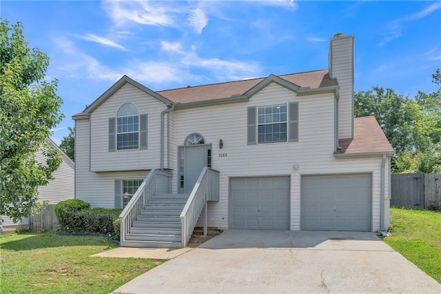 7262 Sandpiper Way, Riverdale, GA 30274 - bi-level home with driveway, a chimney, an attached garage, and roof with shingles