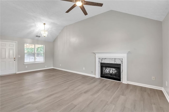 7262 Sandpiper Way, Riverdale, GA 30274 - unfurnished living room with lofted ceiling, a ceiling fan, a chandelier, wood finished floors, and a high end fireplace