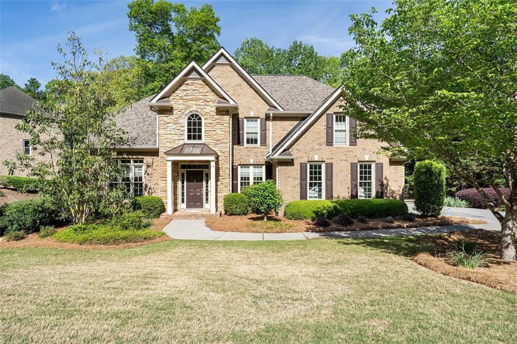 1459 Hickory Branch Trl NW, Kennesaw, GA 30152 - view of front of house featuring stone siding, a front lawn, and brick siding