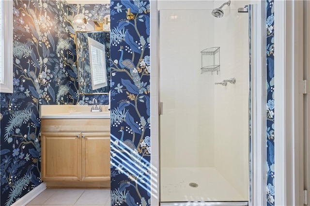 bathroom with a shower stall and wallpapered walls