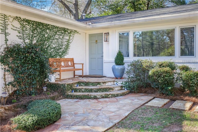 doorway to property with brick siding