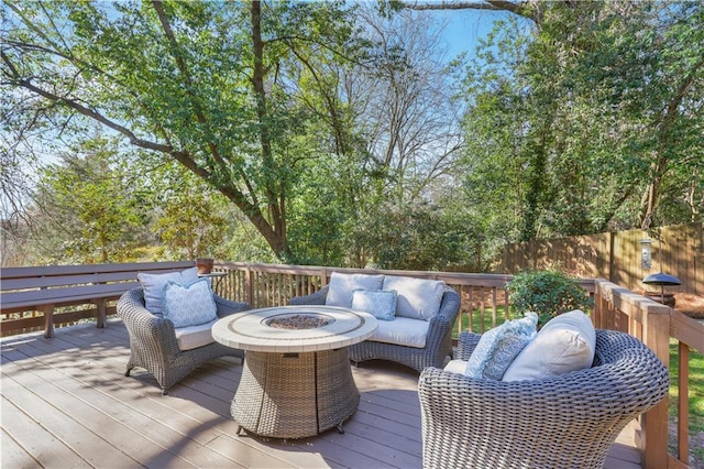 deck with an outdoor living space with a fire pit