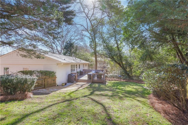 view of yard with a wooden deck and fence