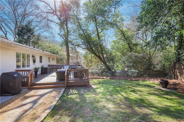 view of yard featuring fence and a wooden deck