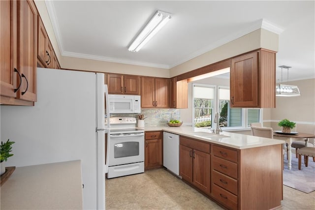 kitchen featuring a sink, white appliances, a peninsula, brown cabinetry, and light countertops