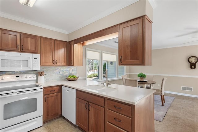 kitchen with white appliances, visible vents, light countertops, crown molding, and tasteful backsplash