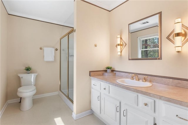 bathroom featuring vanity, a shower stall, toilet, and ornamental molding