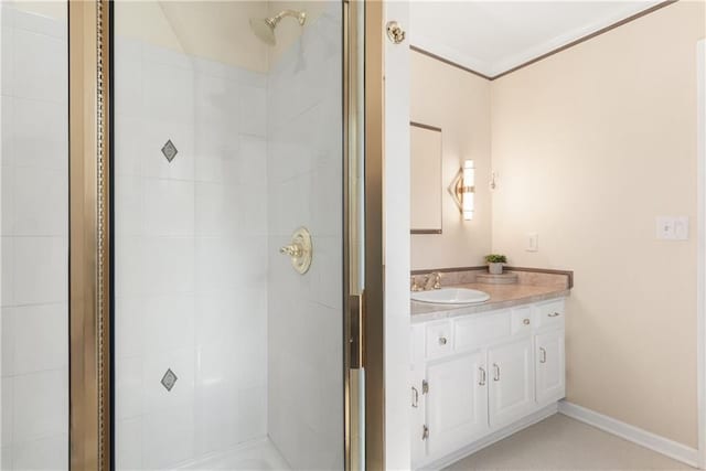 full bath featuring a shower stall, vanity, and baseboards