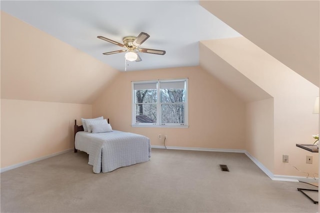 bedroom with vaulted ceiling, carpet flooring, visible vents, and baseboards