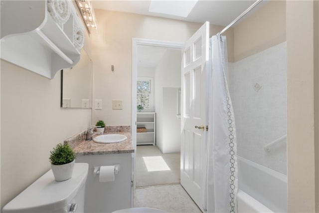 full bathroom featuring vanity, a skylight, and shower / tub combo