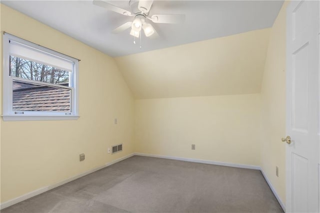 additional living space featuring vaulted ceiling, baseboards, visible vents, and light carpet