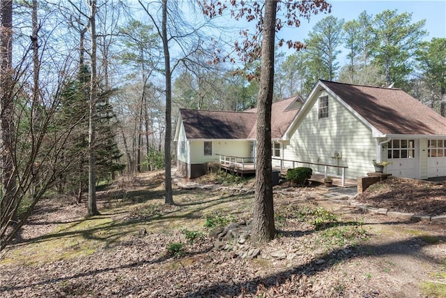 view of side of property with central AC and a wooden deck