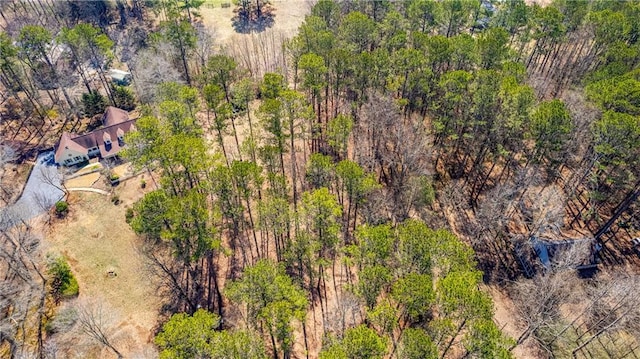 drone / aerial view with a wooded view