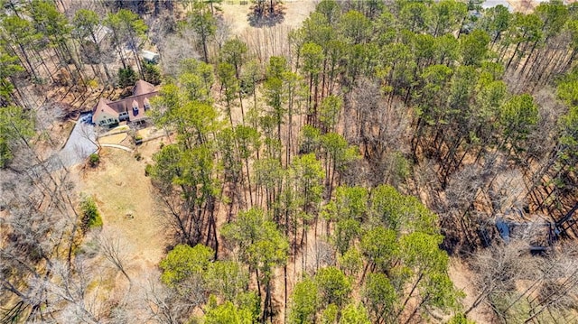 birds eye view of property featuring a wooded view